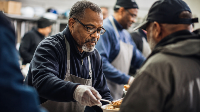 A respected leader quietly helping others without seeking attention, reflecting humility, service, and strength.